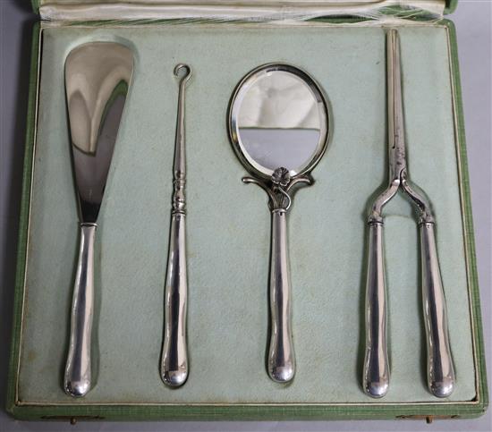 A cased early 20th century continental 800 standard white metal handled dressing set